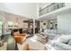 Open-concept living room with high ceilings, hardwood floors, and easy access to kitchen and dining area at 5868 Savona Ter, Fort Mill, SC 29708