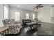 Open living room boasts elegant armchairs, a comfortable sofa, and hardwood floors at 5868 Savona Ter, Fort Mill, SC 29708