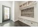 A mudroom area features a built-in bench, storage drawers, coat hooks and gray wood flooring at 5868 Savona Ter, Fort Mill, SC 29708