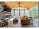 Relaxing screened-in porch with stone fireplace and a scenic outdoor view at 5868 Savona Ter, Fort Mill, SC 29708