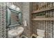 This powder room features patterned wallpaper, rustic shelves and a pedestal sink at 5868 Savona Ter, Fort Mill, SC 29708