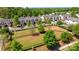 Aerial view showcasing townhomes, a park, and lush greenery within the neighborhood at 5908 Glassport Ln, Charlotte, NC 28210