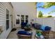 Inviting back patio with comfortable outdoor seating and a view of the backyard and home exterior at 5908 Glassport Ln, Charlotte, NC 28210