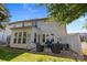 Charming back patio features a brick paver floor, comfortable seating, and a view of the home's exterior at 5908 Glassport Ln, Charlotte, NC 28210