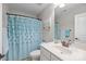 Charming bathroom with a decorative shower curtain and a vanity with ample counter space at 5908 Glassport Ln, Charlotte, NC 28210