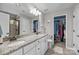 Bright bathroom boasts double vanity with granite countertops and two walk-in closets for ample storage at 5908 Glassport Ln, Charlotte, NC 28210