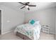 Neutral bedroom showcasing a cozy bed with floral bedding, side tables, and a ceiling fan at 5908 Glassport Ln, Charlotte, NC 28210