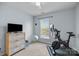 Spare bedroom featuring an exercise bike, TV, neutral paint, and carpet at 5908 Glassport Ln, Charlotte, NC 28210