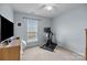 Spare bedroom featuring an exercise bike, TV, neutral paint, and carpet at 5908 Glassport Ln, Charlotte, NC 28210