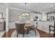 Elegant dining room featuring a chandelier, hardwood floors, and seamless access to the kitchen at 5908 Glassport Ln, Charlotte, NC 28210