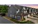 Beautiful townhouse featuring an attached garage, manicured landscaping, and a sidewalk at 5908 Glassport Ln, Charlotte, NC 28210
