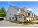Pleasant curb appeal with brick and siding townhome featuring front yard landscaping at 5908 Glassport Ln, Charlotte, NC 28210
