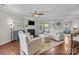 Bright living area with a fireplace, ceiling fan, hardwood floors, and plenty of space for relaxation at 5908 Glassport Ln, Charlotte, NC 28210