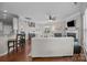 Spacious living room with hardwood floors, a fireplace, barstool seating, and an open staircase at 5908 Glassport Ln, Charlotte, NC 28210