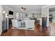 Open-concept living room with hardwood floors, a fireplace, and seamless flow into the kitchen area at 5908 Glassport Ln, Charlotte, NC 28210