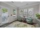 Cozy sunroom filled with natural light, stylish seating, and hardwood flooring at 5908 Glassport Ln, Charlotte, NC 28210