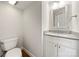 Bright powder room featuring a modern vanity and wood flooring at 6201 Creola Rd, Charlotte, NC 28270