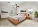 Brightly lit bedroom with a ceiling fan, two windows and natural wood furniture at 6201 Creola Rd, Charlotte, NC 28270