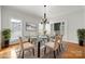 Elegant dining room with a glass-top table, stylish chairs, and ample natural light, creating a sophisticated dining experience at 6201 Creola Rd, Charlotte, NC 28270