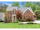Charming two-story brick home with a lush front yard and well-maintained landscaping, providing great curb appeal at 6201 Creola Rd, Charlotte, NC 28270