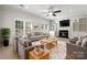Cozy living room with a fireplace, comfortable seating, and natural light, ideal for relaxation and gatherings at 6201 Creola Rd, Charlotte, NC 28270