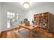 Bright home office with a spacious desk, bookshelf, and French doors, providing a functional and inviting workspace at 6201 Creola Rd, Charlotte, NC 28270