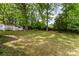 A treed backyard with a small garage and space to play at 627 Gray Dr, Charlotte, NC 28213