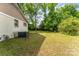 A spacious backyard with trees and grass, offering ample outdoor space at 627 Gray Dr, Charlotte, NC 28213