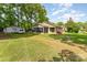 Well-maintained single-story house with screened porch, detached garage, and mature trees at 627 Gray Dr, Charlotte, NC 28213