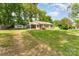 Quaint single-story house with a screened porch and a detached garage on a large, grassy lot at 627 Gray Dr, Charlotte, NC 28213
