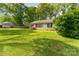 Charming single-story brick home with lush lawn and mature landscaping at 627 Gray Dr, Charlotte, NC 28213