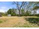 Expansive backyard featuring lush trees and an charming shed, perfect for outdoor activities at 6525 Kershaw Camden Hwy, Heath Springs, SC 29058