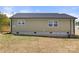 Backyard view of a one-story home with neutral siding and a small deck at 6525 Kershaw Camden Hwy, Heath Springs, SC 29058