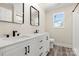 Modern bathroom with double sink vanity, black fixtures, decorative mirrors, and lots of storage at 6525 Kershaw Camden Hwy, Heath Springs, SC 29058