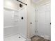 Bathroom featuring a walk-in shower with black fixtures and two white doors at 6525 Kershaw Camden Hwy, Heath Springs, SC 29058