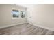 Light-filled bedroom featuring wood floors and bright windows with natural light at 6525 Kershaw Camden Hwy, Heath Springs, SC 29058