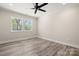 This bright bedroom features hardwood floors, neutral paint, ceiling fan, and double windows at 6525 Kershaw Camden Hwy, Heath Springs, SC 29058