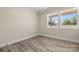 Neutral bedroom with hardwood floors, baseboard trim, and double windows at 6525 Kershaw Camden Hwy, Heath Springs, SC 29058
