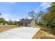One-story home with a covered porch, neutral color palette and a large front driveway at 6525 Kershaw Camden Hwy, Heath Springs, SC 29058