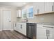This kitchen features white cabinets, stainless steel appliances, sleek countertops and a contemporary faucet at 6525 Kershaw Camden Hwy, Heath Springs, SC 29058
