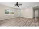 Bright living room with wood-look floors, neutral paint, large windows and modern ceiling fan and lighting at 6525 Kershaw Camden Hwy, Heath Springs, SC 29058