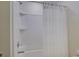 Clean bathroom showcasing a white bathtub and shower combination with a white shower curtain and chrome fixtures at 712 Chase Ct, Fort Mill, SC 29708