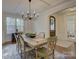 Elegant dining room with a large wooden table, chandelier, and natural light from the window at 712 Chase Ct, Fort Mill, SC 29708