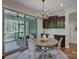 Cozy dining nook with modern chandelier, access to screened patio and custom cabinets at 712 Chase Ct, Fort Mill, SC 29708