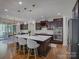 Stunning kitchen island featuring white countertops, dark cabinets, pendant lighting and bar stool seating at 712 Chase Ct, Fort Mill, SC 29708