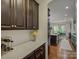 Kitchen featuring dark wood cabinets, marble countertops, and an open layout to the dining area at 712 Chase Ct, Fort Mill, SC 29708