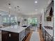 Gourmet kitchen boasts an oversized island, a stainless steel range, and eat-in dining area at 712 Chase Ct, Fort Mill, SC 29708