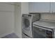 Updated laundry room with high-efficiency washer and dryer on custom tile flooring and storage cabinets at 712 Chase Ct, Fort Mill, SC 29708