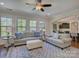 Bright living room featuring large windows, plush seating and access to kitchen and dining area at 712 Chase Ct, Fort Mill, SC 29708