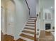 Staircase leading to the second level with hardwood steps and white risers at 712 Chase Ct, Fort Mill, SC 29708
